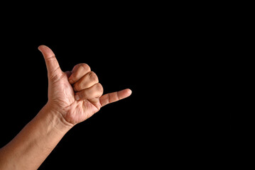 Close-Up of Hand Making Shaka Gesture with Black Background
