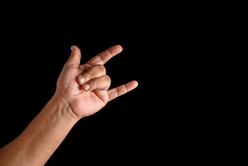Hand Showing Rock Gesture on a Black Background for Conceptual Use