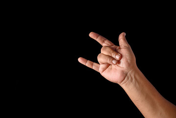 Hand Showing Rock Gesture on a Black Background for Conceptual Use