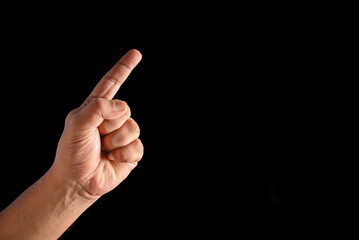 Male Hand Pointing Forward Gesture Isolated Against a Dark Background