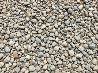 Natural gray pebble stone texture background with smooth rounded shapes
