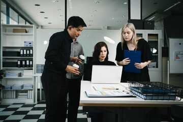 Four colleagues engage in a collaborative office meeting, using laptops, tablets, and documents to brainstorm ideas, discuss strategies,share insights, fostering teamwork, productivity, professional