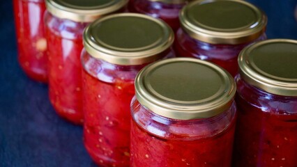 Glass Jars Filled with Homemade Tomato Sauce, Traditional Preparation for Winter Preservation