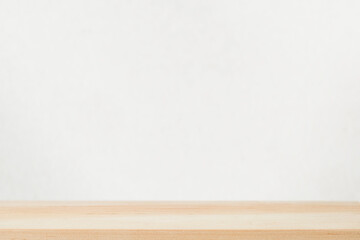 Empty light wood table top against gray wall. Design element. Backdrop for your advertising presentation.