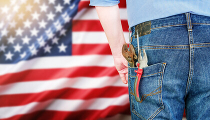 Man or male with hand tools and work clothes in pocket and American flag against. Labor Day backgrounds. Concept of work and employment. Happy Labour day concept. Design element.