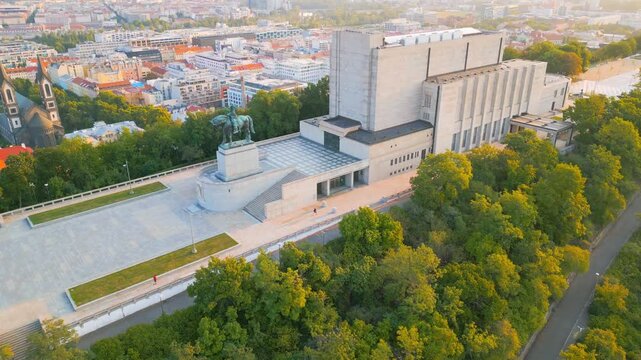 Experience a serene morning at Vitkov Hill in Prague. Witness the majestic National Monument dedicated to Jan Zizka as the sun rises, illuminating the landscape and captivating atmosphere.