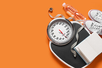 Scales with measuring tape, sport shoes and bottle of water on orange background. Weight loss concept