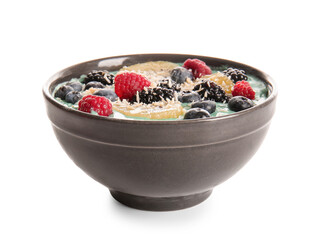 Bowl with tasty spirulina smoothie and berries on white background, closeup
