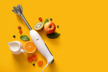 Modern blender with jug of milk, fruits and berries on yellow background