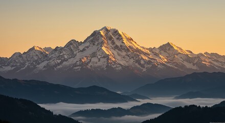 Snowy mountain peak above misty valley