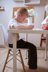 A boy with hearing aids engages with a smartphone, playing mobile games with focused enjoyment....