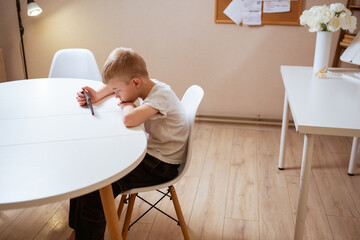 A boy with hearing aids engages with a smartphone, playing mobile games with focused enjoyment....