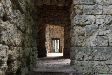 Passage carved from rough-hewn stone blocks.