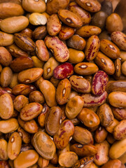 Close up of assorted brown and red speckled dry beans background
