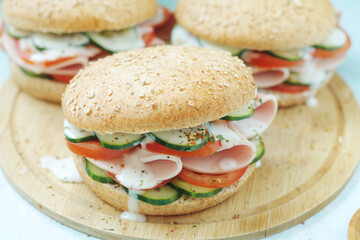 Bun sandwiches with salami and vegetables