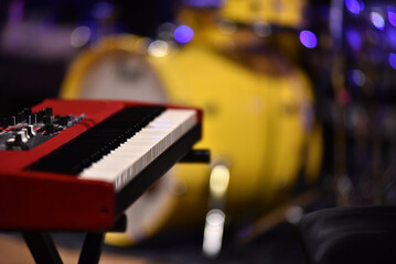 Keyboard instrument and drums in stage lights