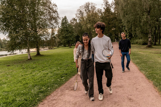Badminton. Multigenerational family active recreation in nature.