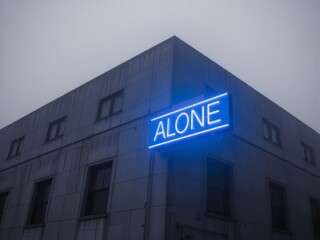 Obraz premium Neon sign reading 'ALONE' on modern building in overcast weather 