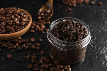 Jar with coffee body scrub on black grunge background, closeup