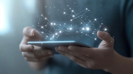 Human hands hold a modern digital tablet displaying an illuminated global network of interconnected data points