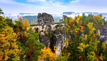 Autumnal bridge over sandstone peaks