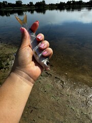 woman holds a freshwater fish