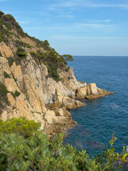 Rocky coastline cliffs with blue sea ocean horizon natural scenic marine landscape summer vacation travel seascape view