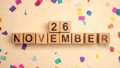 Wooden Blocks with Date 26 November. Calendar for birthday or anniversary on solid colored background with confetti