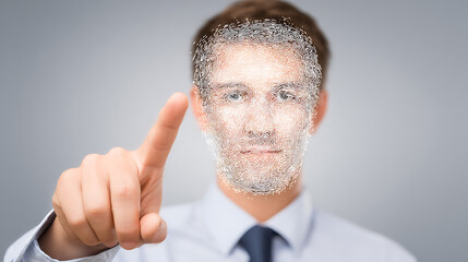 Man pointing at camera with face partially transformed into digital particles