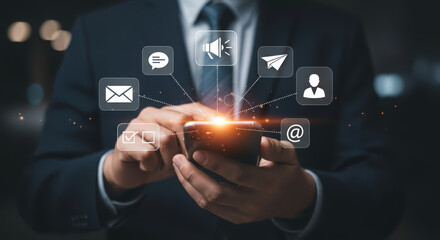 Businessman in formal attire using smartphone with digital communication icons, representing modern technology and connectivity in a professional environment