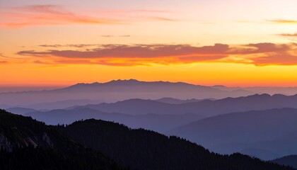 Fototapeta premium Sunset hues paint layers of distant mountains