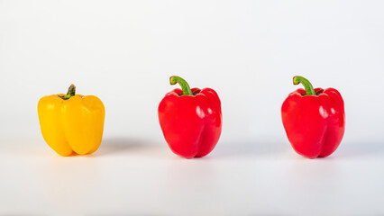Red,yellow and green sweet peppers on white background