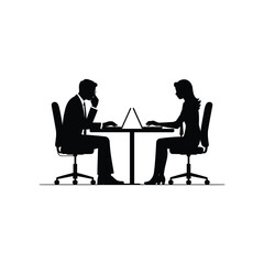 Silhouette of two business people working on laptops at a table in an office setting