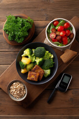 Balanced and wholesome meal: broccoli, tomatoes, grains, and greens on a wooden board, promoting healthy eating and lifestyle.