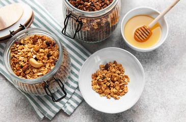 Granola with nuts and dried fruits in glass jars