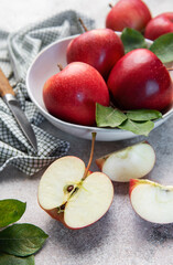Fresh red apples in bowl with knife
