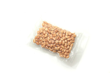 roasted peanuts in vacuum-sealed plastic packaging isolated on white background, good for food article or recipe