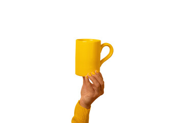 A hand in a yellow sleeve holding a bright yellow ceramic mug on transparent background, perfect for advertising, branding, or editorial use.