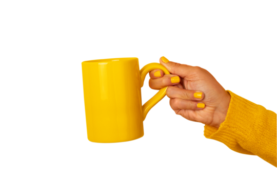 Female hand holding a vibrant yellow ceramic mug against transparent background. Colorful, minimal, and suitable for coffee, tea, breakfast, or lifestyle concepts.