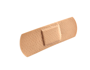 A light brown adhesive bandage, rectangular with rounded ends, features a square absorbent pad in the center and a dotted texture