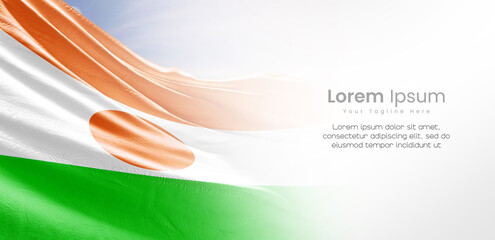 Niger national flag waving and fading on white background. The flag uses for banner and poster with...