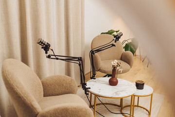 Podcast studio setup featuring professional microphones and cozy seating for engaging conversations