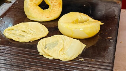 Fried roti in hot pan.