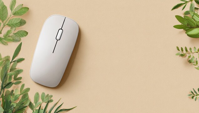 Light beige surface with a white computer mouse and sprigs of greenery