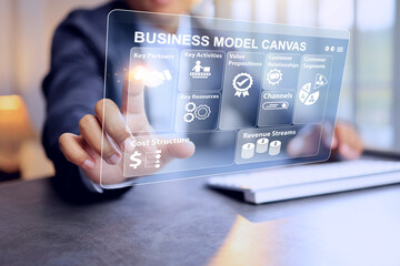 BMC concept with businessman working on business model canvas on computer to planning and study for market research information before start new business scheme