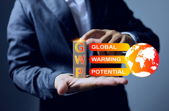 Low GWP or global warming potential concept with businessman arrange wooden block to encourage the business to reduce a global warming potential