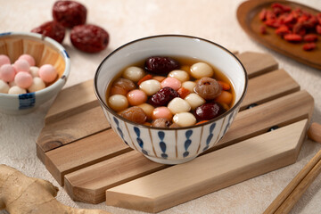 Homemade red and white tangyuan with syrup soup, dried longan pulp, red dates for Winter solstice.