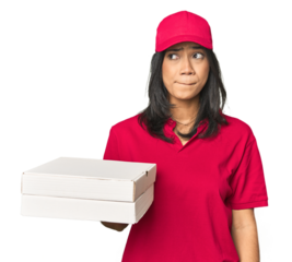 Latina delivering pizza, studio setup confused, feels doubtful and unsure.