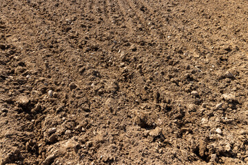 brown-colored plowed soil, a field after harvest, a field where agricultural activity is carried out in Europe