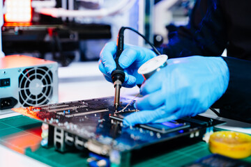 The technician repairing the motherboard in the lab with copy space. the concept of computer hardware, mobile phone, electronic, repairing, upgrade
